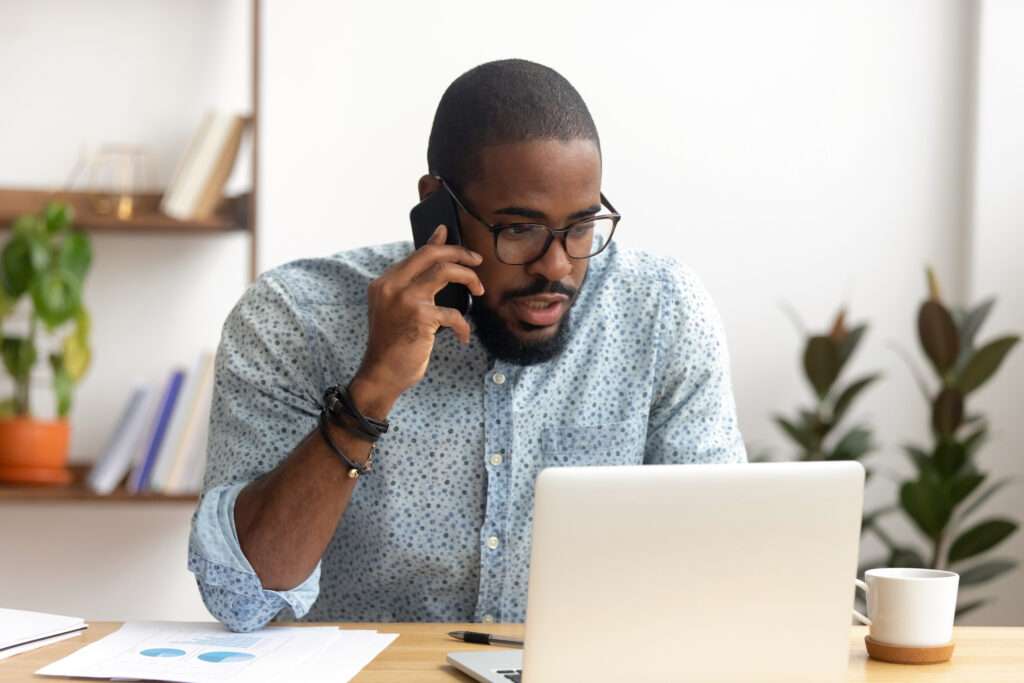 African american man using laptop for intelligent rules-based scheduling software