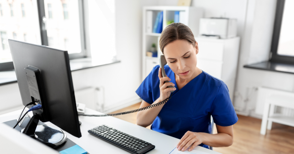 female healthcare provider on telephone managing patient scheduling