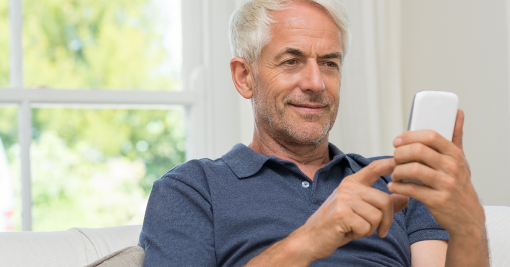 gentleman using mobile device for patient self-scheduling appointments