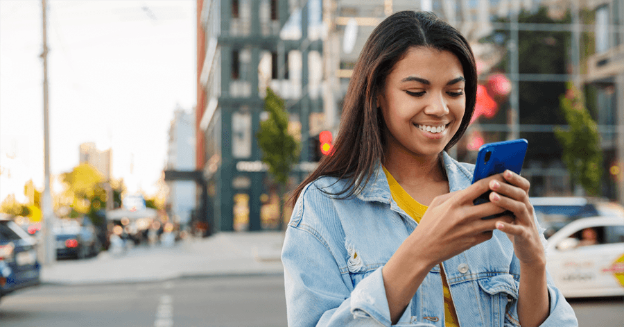 Woman using mobile phone and healthcare open scheduling apis for patient appointments