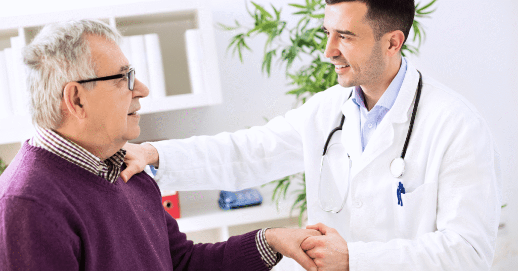 physician explaining healthcare online payment options to elderly patient