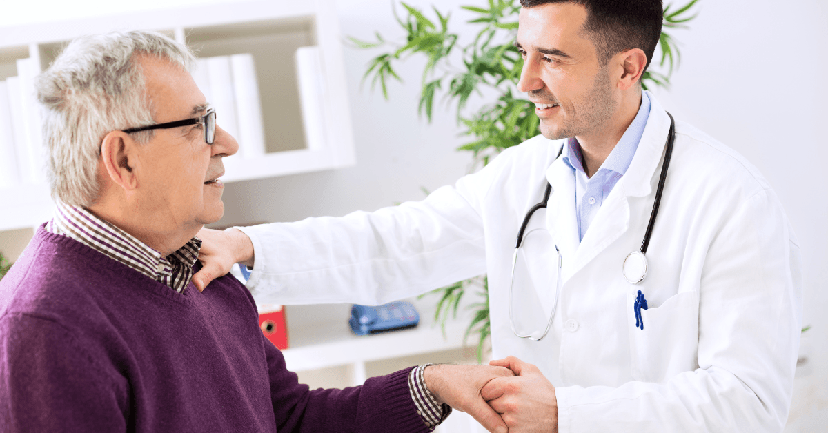 physician explaining healthcare online payment options to elderly patient