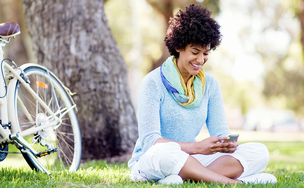 woman using cell phone to self-schedule patient appointment